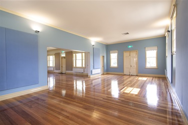 Former courthouse area, looking towards large doorless interface with the main hall and main entry of the building