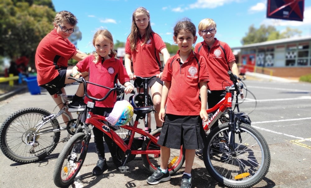 Children on bikes at a school