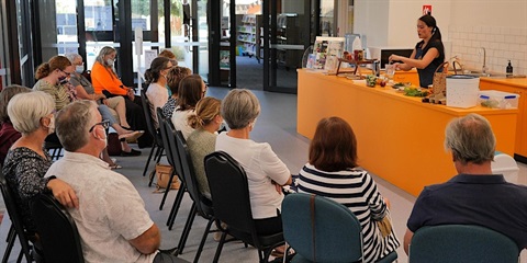 Woman demonstrating how to use induction cook top