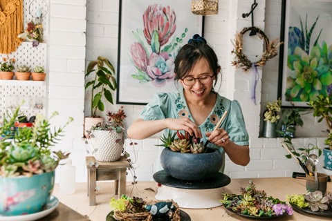 Woman tending to a potted plant