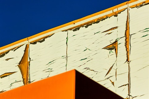 Peeling paint on a wall with sky