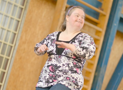 A disabled woman enjoys dance class.