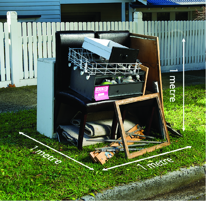 A single collection of hard waste, neatly stacked on a nature strip in front of a house within the 1 cubic metre threshold, 1 cubic metre represented by a space 1m wide, 1m deep and 1m tall